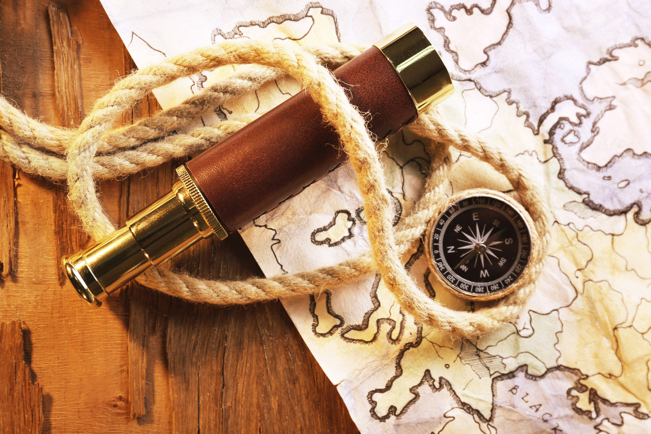 Spyglass, Compass, Rope, and World Map on a Table